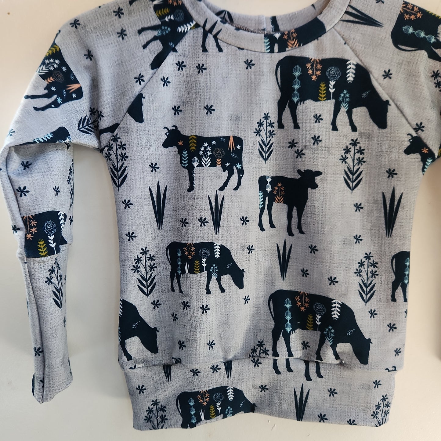 MooMoo Meadows Cow Print Grow-with-me Sweater