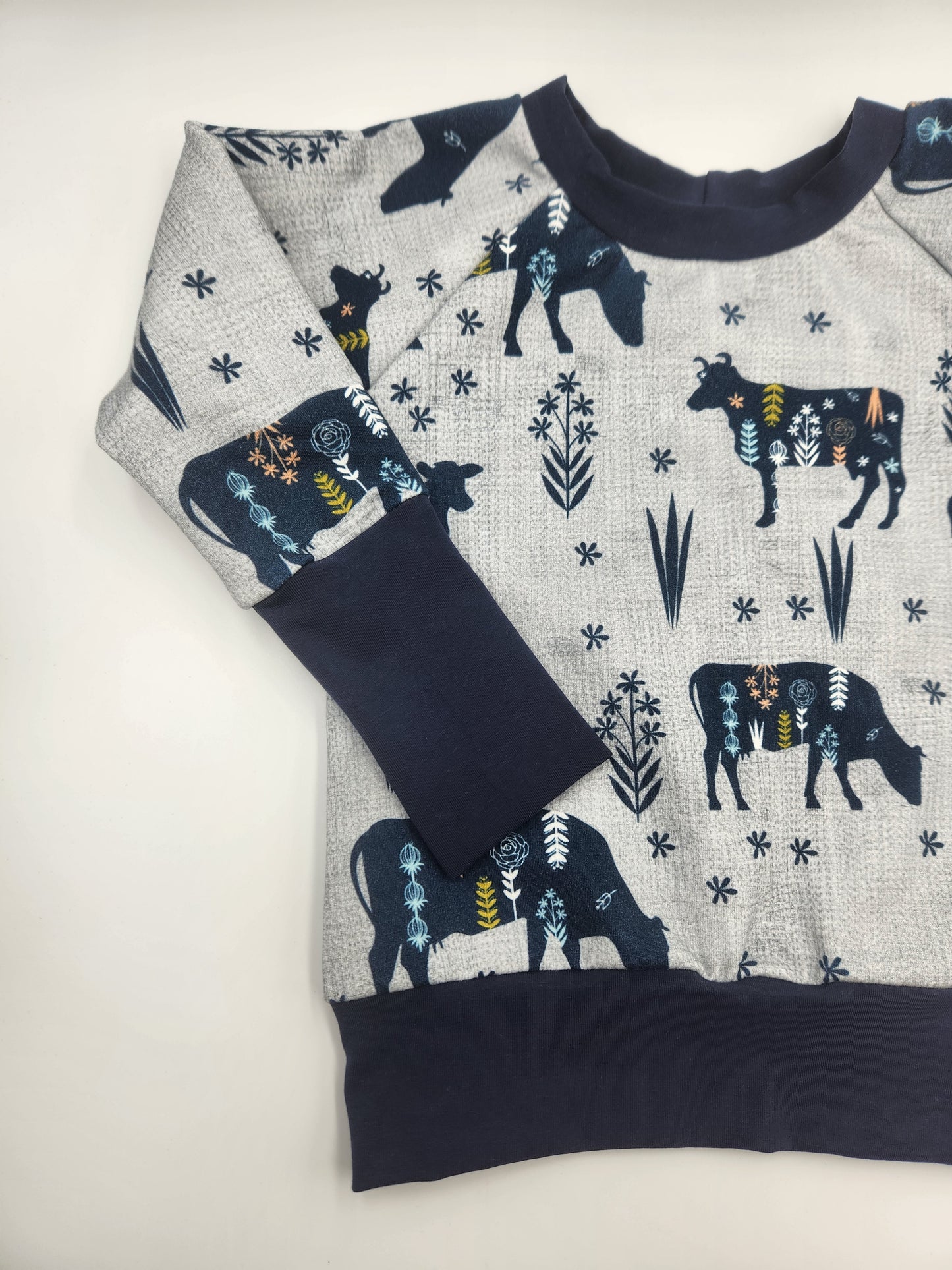 MooMoo Meadows Cow Print Grow-with-me Sweater